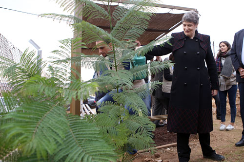 UNDP Administrator Helen Clark waters trees at St George’s Church in Mafraq during an official visit on Sunday (Photo by Raad Adayleh)